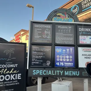a menu board and a car in front of a building