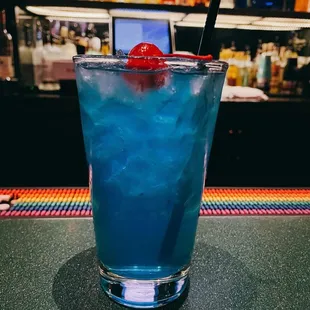 a blue drink with a straw
