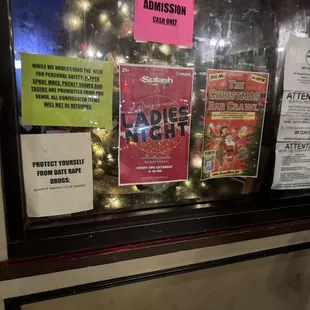 a window display with a christmas tree in the background
