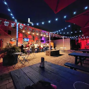 a group of people sitting under umbrellas
