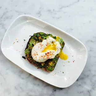 Avocado toast with poached egg on Josey Baker bread