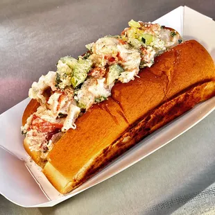 Maine lobster roll on a warm toasted split top bun.