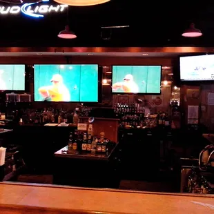 a bar with multiple televisions