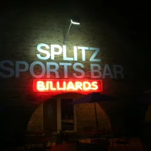 a neon sign on the side of a building