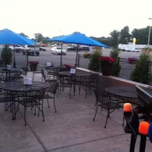 tables and chairs with blue umbrellas