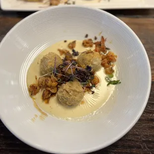 Seafood stuffed eggplant ball with hollandaise.