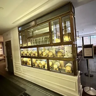 a display of wine barrels in a glass case
