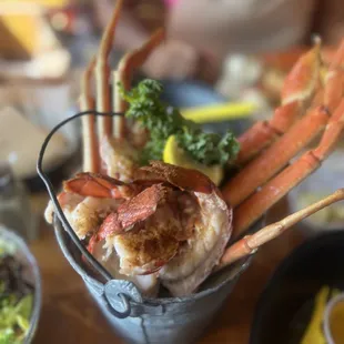 crab legs and broccoli in a bucket