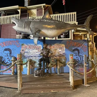 a statue of a man riding a shark