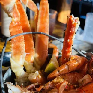 a bowl of crab legs and claws