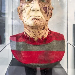 a man's face in a glass case