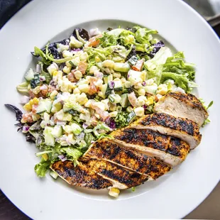 BLACKENED CHICKEN SALAD: 
blackened chicken, roasted corn, cucmber, diced tomato with buttermilk dressing
