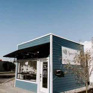 a blue building with a sign on it