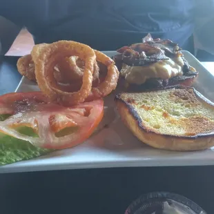 Very fat bacon cheeseburger with onion rings and all the fixin's