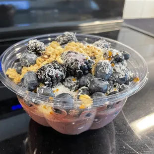 a bowl of blueberries and granola