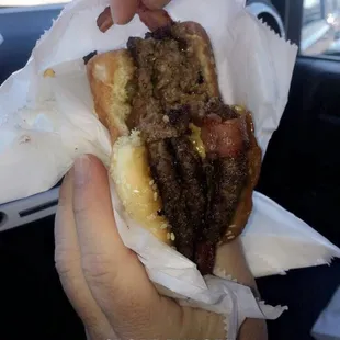 Triple cheese burger with bacon cooked to perfection!