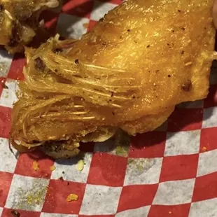 CHICKEN FEATHERS fried into the wing! I called the waiter over she told me "your eyes are deceiving you,that's skin" ABSOLUTELY Disgusting!!