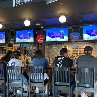 a group of people sitting at a bar