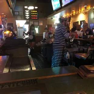 a man in a striped shirt at the bar
