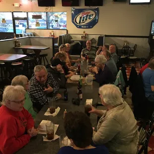 a large group of people sitting around a table