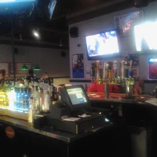 a bar with a lot of bottles on the counter