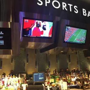 the bar and televisions in the background