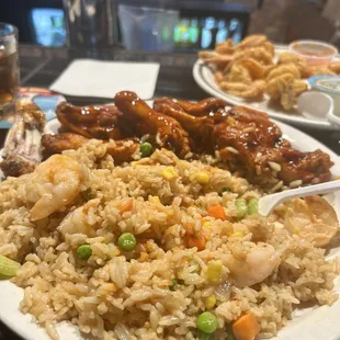 a plate of fried rice with meat and vegetables