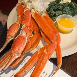 crab legs and broccoli on a plate