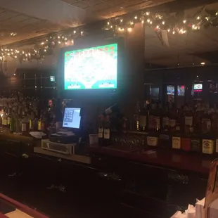 a bar with a television and a laptop