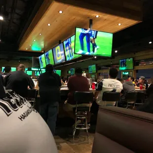 a group of people watching televisions