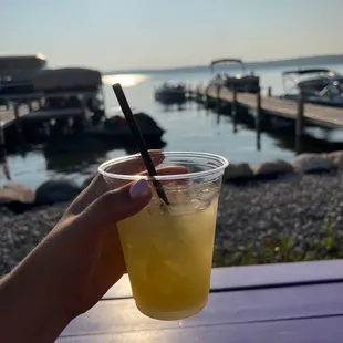 a person holding a drink with a straw