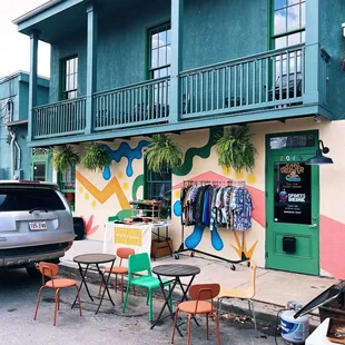 a car parked outside a colorful building