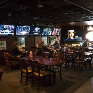a sports bar with several televisions