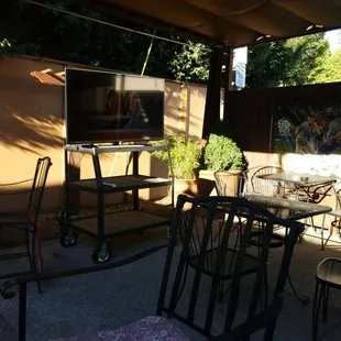a patio with tables and chairs