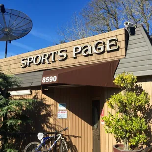 a bicycle parked outside of a sports page