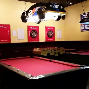 a billiards room with pool tables