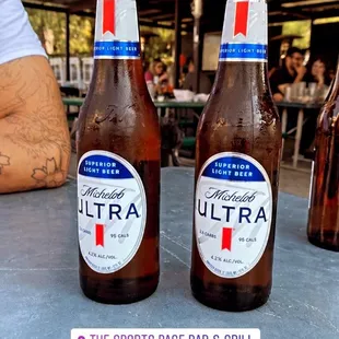 two bottles of beer on a table