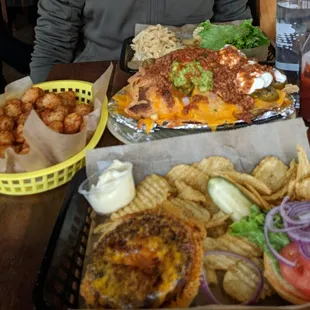 Nachos, brisket burger (far top) tater puffs on the left and a veggie burger for me