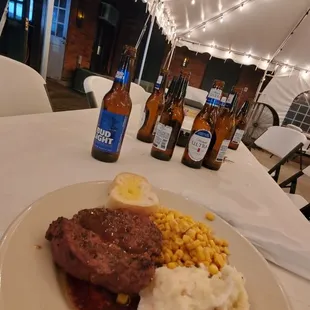 steak, mashed potatoes, corn and beer