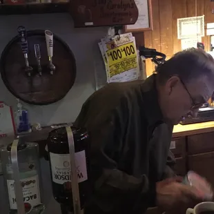 a man preparing a drink at a bar