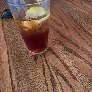 a glass of iced tea on a table