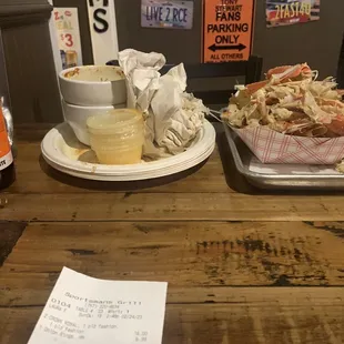 two plates of food and a bottle of beer