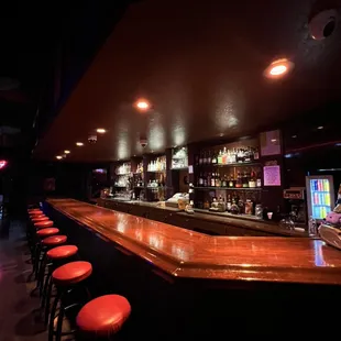 a bar with red stools