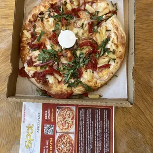 Cheese pizza with pineapple, red onions , sun dried tomatoes and basil toppings.