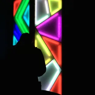 a man standing in front of a colorful stained glass window