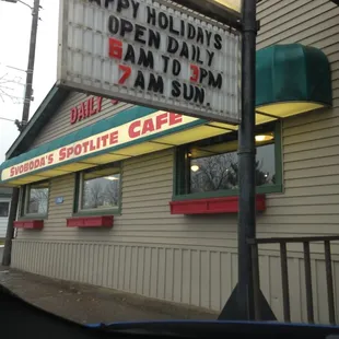 a sign for a happy holiday's open day