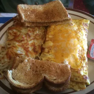 Omelette with crispy hashers and toast