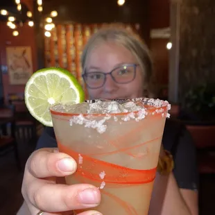 a woman holding a margarita