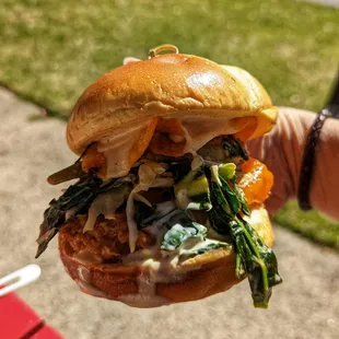 a hand holding a sandwich