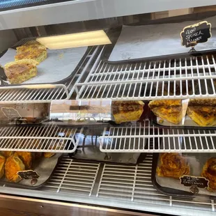 a variety of pastries in a display case